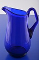 Holmegaard 
glasværk. Fin 
blå kande / 
vandkande, 
højde ved hank 
18,5 cm. Kan 
indeholde 100 
cl. ...