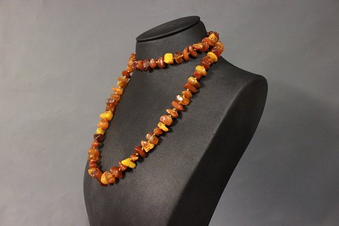 Long necklace of large amber pieces and delicate silver Lock.
5000m2 showroom.