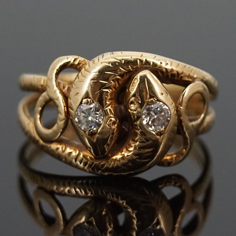 A ring set with 2 diamonds mounted in 14k gold, a snake
