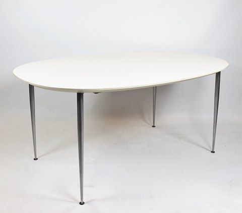 Dining table with white laminate and steel legs of danish design.
5000m2 showroom.
