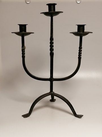 Three-armed iron candlestick