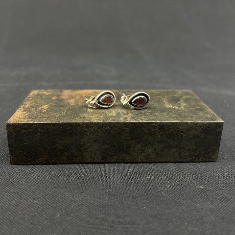A pair of ear studs with grenades