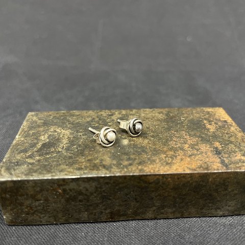 A pair of small silver ear studs