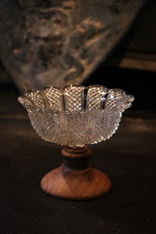 Old Swedish 1800 century bowl in pressed glass 
mounted with wooden foot. H:10cm. Dia.:12cm.