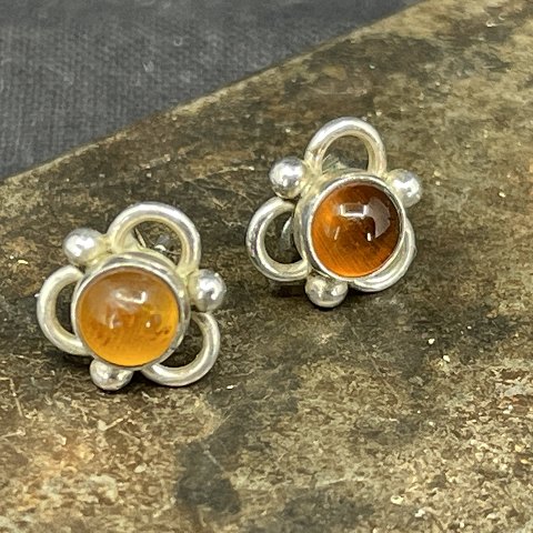 A pair of ear studs with amber