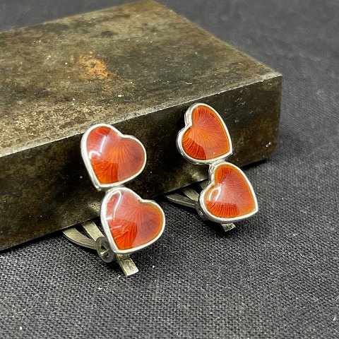A pair of ear clips with red enamel