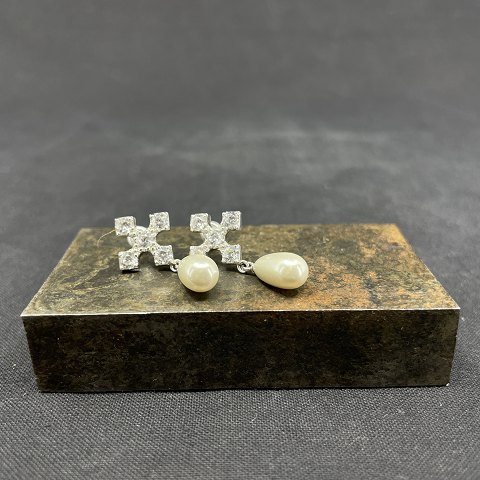 A pair of ear studs with elongated pearls