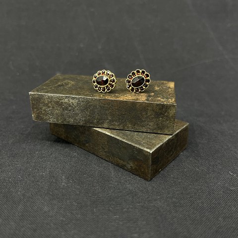 A pair of earrings with garnets