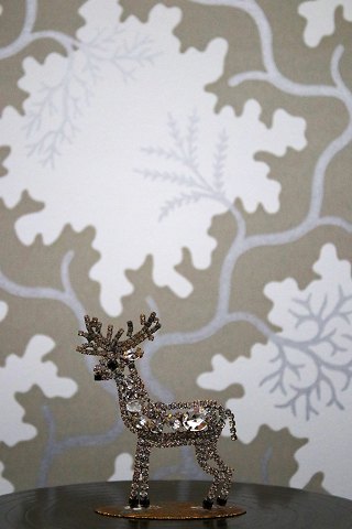 Decorative, old reindeer in metal decorated with rhinestones and crystals in 
glass from Bohemia. H:9cm.