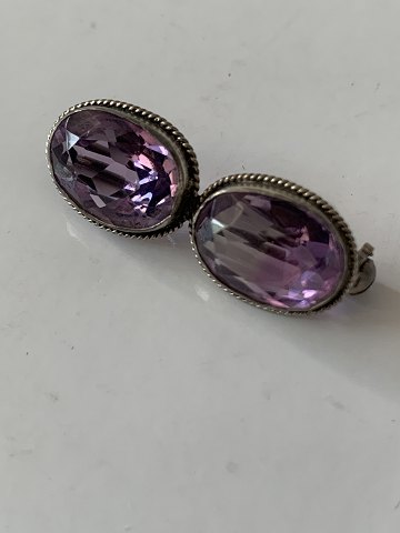 Brooch with beautiful purple stones, in vintage and antique style.