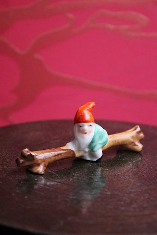 Old elf knife chair in the shape of a tree trunk with a sitting elf in 
porcelain...