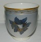 Smaller vase in 
porcelain from 
Bing & Grøndahl 
decorated in 
blue and gold 
with 
butterflies. In 
...