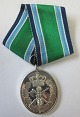 Medalje i sølv, 
for 25 års 
frivillig 
tjeneste i 
Hjemmeværnet. 
Danmark. Med 
bånd. H.: 8,5 
cm. 