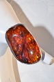 Ring af 
sterling 925s, 
with amber. By 
: Erik 
Styrbech, 
Snedsted 1964- 
?. Denmark.  
Size 57/ 18.2 
...