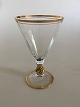 Holmegaard Ida 
rødvinsglas med 
guld på stilk, 
rand og 
fod. Måler 14,5 
cm Høj. 9,3 cm. 
diameter. 
