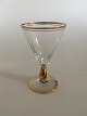 Holmegaard 
"Ida" 
hedvinsglas med 
guld på stilk, 
rand og fod. 
Måler 10,4 cm 
Høj x 6,5 cm 
diameter.