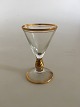Holmegaard Ida 
snapsglas med 
guld på stilk, 
rand og 
fod. 8,2 cm 
Høj. 5,3 cm 
diameter. 
