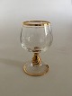 Holmegaard 
"Ida" cognac 
glas med guld 
på stilk, rand 
og fod. Måler 
9,2 cm Høj x 
4,7 cm 
diameter. ...