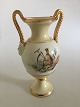 Bing & Grøndahl 
Tidlig vase med 
overglasur 
decoration og 
romersk/græske 
Bisque hoveder.
Måler ...