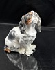 Siddende hund, 
King Charles 
Spaniel 
(Cavalier?) 
Bing og 
Grøndahl (2035)
H.: 15 cm B.: 
11 ...