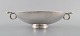 GUSTAV PEDERSEN for Georg Jensen. Large art deco bowl with handles on foot in 
sterling silver.
