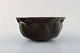 Axel Salto for Royal Copenhagen: Stoneware bowl, modeled in organic form, 
decorated with glaze in aubergine colored tones. 
