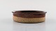 Helle Allpass 
(1932-2000). 
Low bowl of raw 
and glazed 
stoneware in 
brown shades. 
1960 / ...
