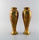 A pair of French art nouveau bronze vases with flowers in relief. Ca. 1890.