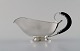 Danish silversmith. Art deco sauce boat in silver (830) with ebony handle. Dated 
1936.
