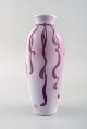 Gunnar Wennerberg for Gustafsberg. Unique art nouveau vase in glazed ceramics. 
Purple ribbon on pink background. Ca 1900.
