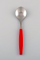 Henning Koppel for Georg Jensen. Strata sorbet spoon in stainless steel and red 
plastic. Seven pcs in stock.
