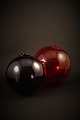 2 pcs. old decorative glass balls from Holmegaard glassworks to hang up. Red, Dia.:15cm.Dark Purple, Dia.13cm.