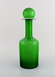 Otto Brauer for Holmegaard. Stor sjælden vase/flaske i lysegrønt kunstglas med 
lysegrøn kugle. 1960
