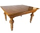 Large dining table of light wood with carvings and three extension plates from 
the 1920s.
5000m2 showroom.