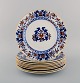 Mintons, England. Nine antique dinner plates in hand-painted faience. Chinese 
style, early 20th century.
