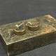 A pair of brass earrings