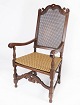 Antik armstol af eg, med original polstring af lyst stof og rørflet, fra 1920erne.H - 118 cm, ...