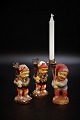 Small old painted elves carrying a small Christmas candle. Height: 11cm.