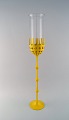 Bjørn Wiinblad 
(1918-2006). 
Large Hurricane 
candlestick in 
yellow 
lacquered metal 
with blue ...