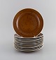 Stig Lindberg for Gustavsberg. 11 Coq lunch plates in glazed stoneware. 
Beautiful glaze in brown shades. Swedish design, 1960s.
