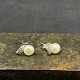 A pair of pearl earrings with stones