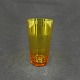 Højde 9 cm.
Cylinderformet 
sodavandsglas 
fra 1930'erne.
Farven er 
gyldent, 
orange, ...