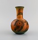 Ipsens enke, Danmark. Art nouveau vase i håndmalet keramik med blomster og bladværk i relief. ...