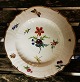 Tallerken i porcelæn fra Ca. 1850 med blomsterdekoration samt sommerfugl og mariehøne. I god ...
