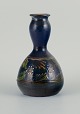 Kähler-vase med 
blå glasur og 
motiv af 
blomster og 
grene.
1930'erne.
I flot ...