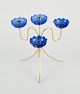 Gunnar Ander for Ystad Metall, a brass candle holder for four candles with blue 
candle sleeves.