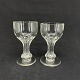 A pair of wine glasses with a hollow stem