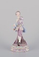 Antique German porcelain figurine. Large figurine of a young man in fine 
clothes. Hand-painted in polychrome colors.