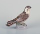 Dahl Jensen for Bing & Grøndahl. Porcelain figurine of a sitting peregrine 
falcon.
