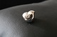 Smuk lille 
charm, udført i 
925 sterling 
sølv, med motiv 
som hjerte med 
klar sten. Fra 
Pandora. ...